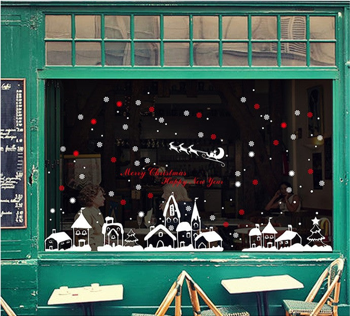 TOTOMO white village and sleigh decorations on a green storefront window