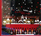 TOTOMO christmas village decals across a shop window above a display of bottles