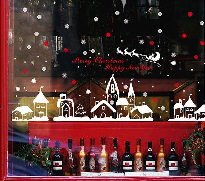 TOTOMO christmas village decals across a shop window above a display of bottles