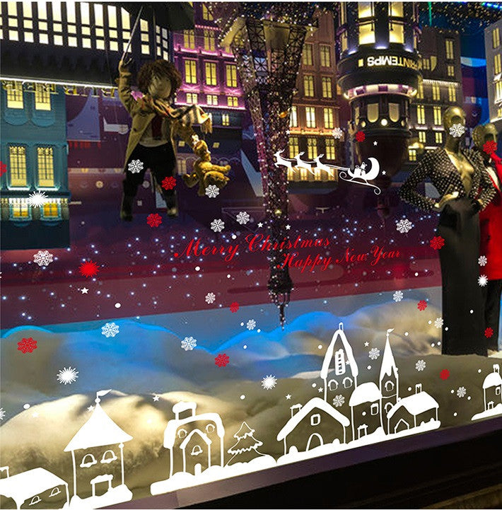 TOTOMO christmas town decals across the lower edge of an illuminated shop window